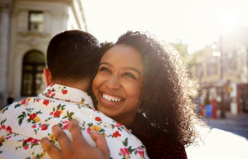 laughing happy woman hugs a man in the city center Atlanta, GA