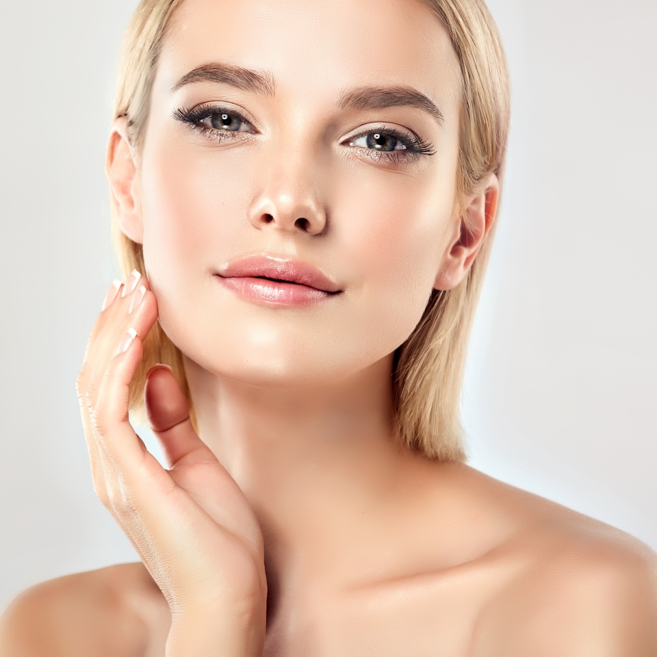 Beautiful Young Woman with Clean Fresh Skin . Facial treatment . Cosmetology , beauty and spa . Blonde girl with short hair and a clean face.