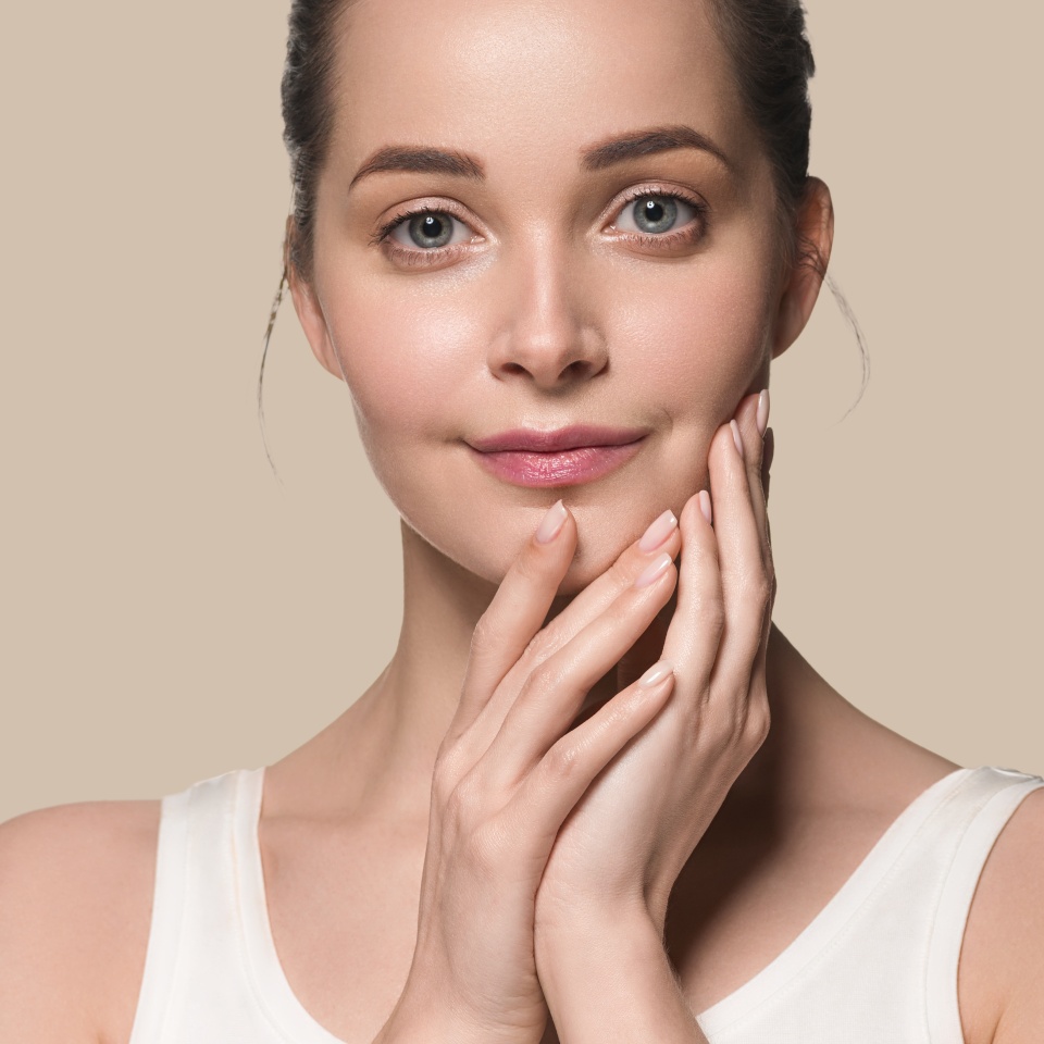 Beautiful skin healthy woman face with manicure nails hand touching healthy clean fresh skin