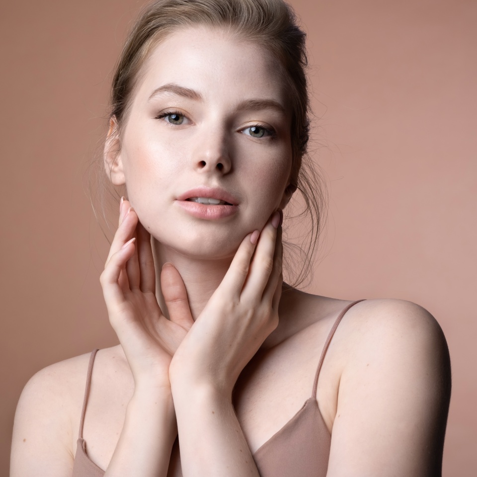 Pretty young caucasian female touching perfect flawless healthy skin. Girl enjoying result after beauty spa treatment, chemical peeling, cosmetics procedure. Cosmetology and dermatology advertising