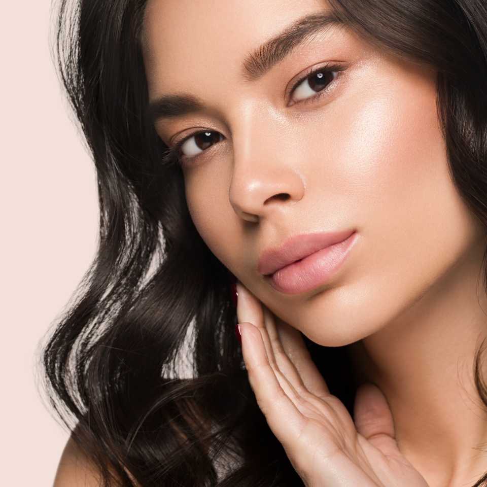 Asia beauty woman touching her face healthy skin close up model portrait. Color background. Pink