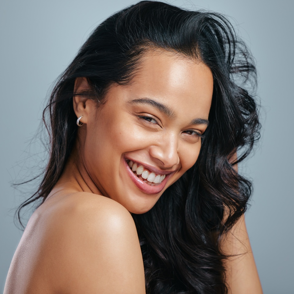 Nourished hair feels so amazing. Studio portrait of an attractive young woman posing against a grey background.