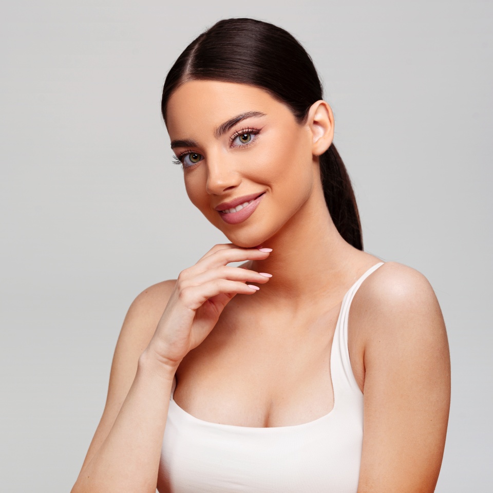 Beautiful woman on bright gray background. Beauty portrait.