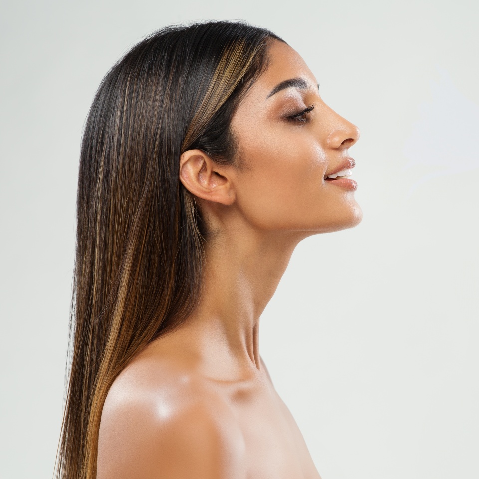 Beauty Girl Face Side View. Beautiful Indian Woman Profile over White. Women Chin and Neck Skin Facelift Massage. Nose Aesthetic Plastic Surgery