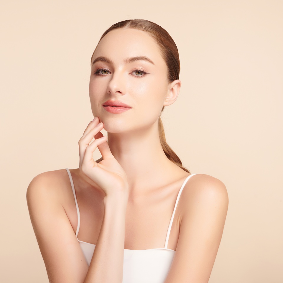 Beautiful young woman with clean fresh skin on beige background, Face care, Facial treatment, Cosmetology, beauty and spa, women portrait.