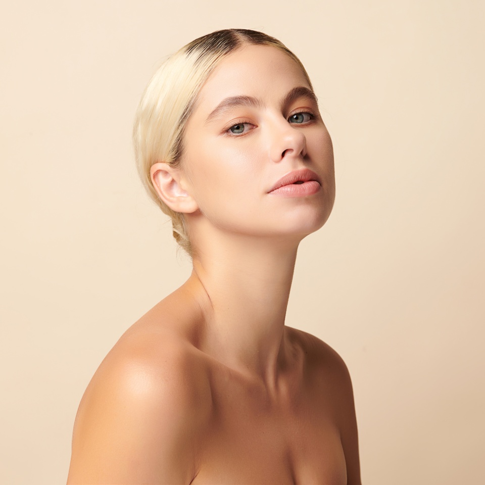 Beautiful young woman with clean fresh skin on beige background, Face care, Facial treatment, Cosmetology, beauty and spa, women portrait.