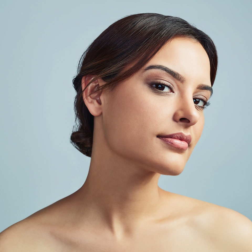 Woman, portrait or beauty in studio for skincare, makeup or confidence with cosmetics. Dermatology, girl or collagen treatment on gray background space with satisfaction, aesthetic or retinol results